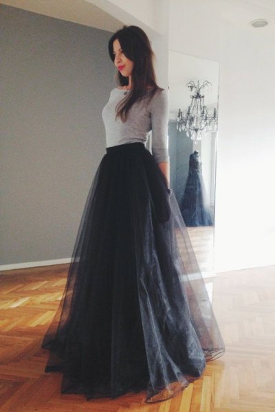 gray, figure-hugging sweater with a black, flared skirt made of long tulle