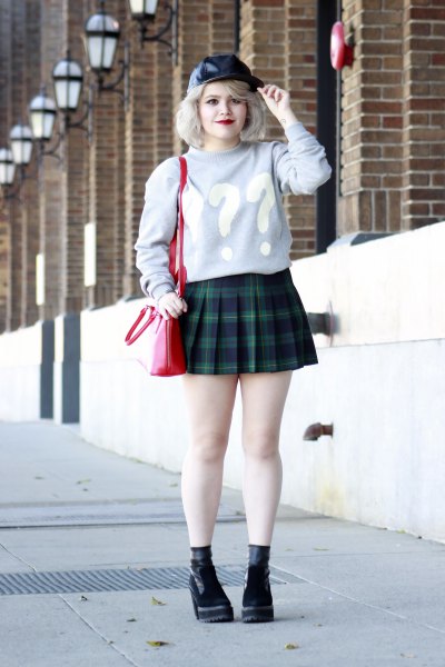 gray graphic sweater with dark blue checked mini pleated skirt