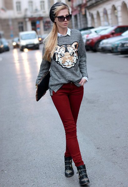 gray graphic sweater with white shirt with buttons and maroon skinny jeans