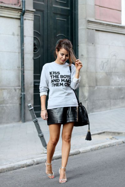gray graphic sweatshirt with black mini leather skirt
