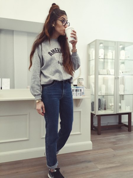 gray graphic sweatshirt with blue mom jeans with cuffs