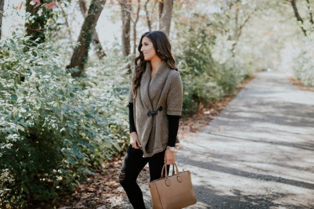 gray half-sleeved sweater with black long-sleeved shirt and brown leather bag