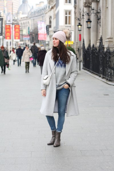gray knitted hat and matching long winter coat and waistband jeans