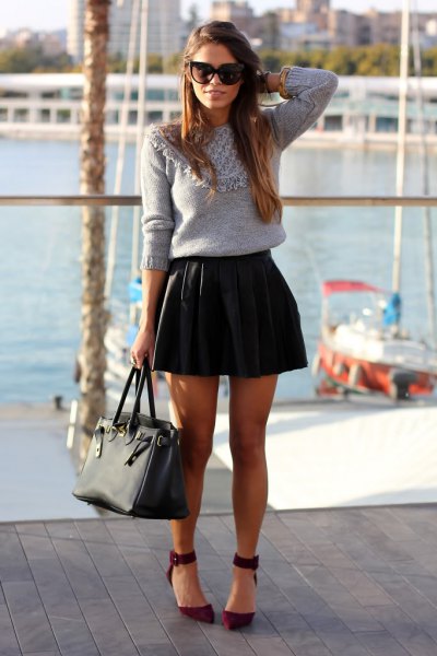 gray knitted sweater with black leather mini pleated skirt