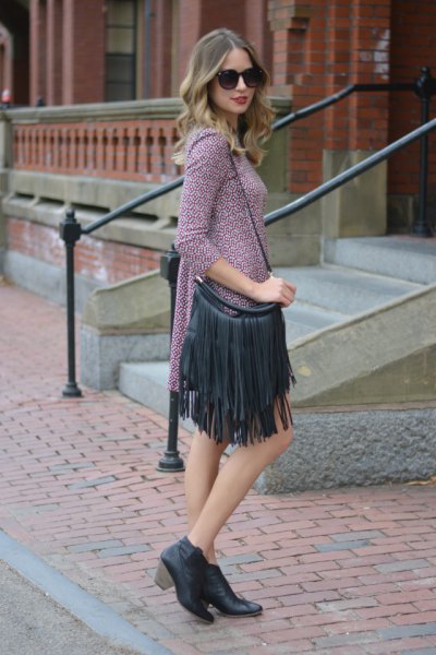 gray knitted mini dress with three-quarter sleeves and black leather wallet with fringes