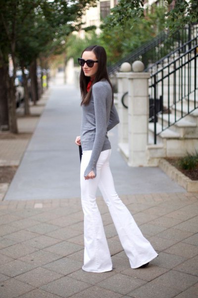 gray, long-sleeved t-shirt with white, flared jeans
