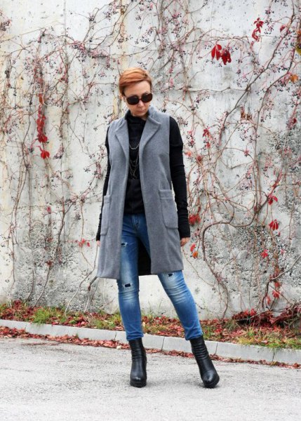gray longline wool vest with blue skinny jeans and black sweater