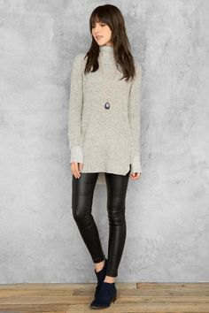 gray tunic sweater with mock neck and black leather gaiters
