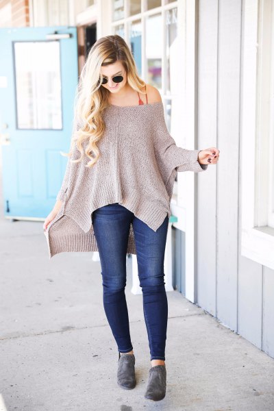 gray off shoulder slouchy sweater with dark blue skinny jeans
