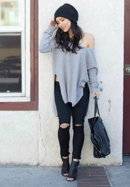 gray oversized sweater with one shoulder and black leather ankle boots