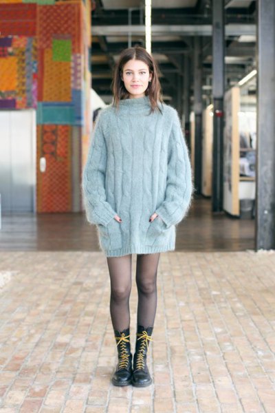 gray, oversized, thick sweater as a mini dress and lace-up boots with a medium calf