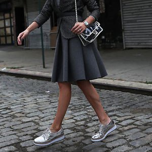 gray mini skirt made of pleated wool with silver sneakers