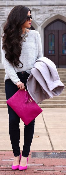gray sweater with pink clutch bag