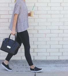 gray relaxed fit t-shirt with black slim fit jeans and sneakers