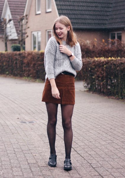 gray, ribbed, coarsely knitted sweater with brown corduroy mini skirt