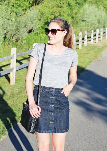 gray t-shirt with scoop neckline and dark blue denim mini skirt with button placket