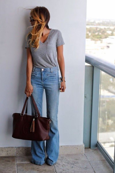 gray t-shirt with scoop neck and light blue jeans