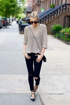 gray, semi-transparent sweater with black jeans and strappy flats