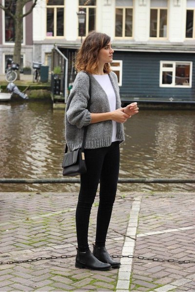 gray, short knitted cardigan with a round neckline and black skinny jeans