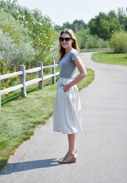 gray short-sleeved T-shirt with vertically striped midi skirt