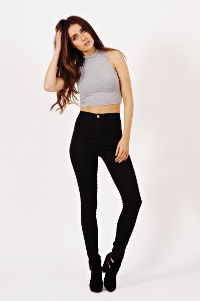 gray sleeveless crop top with black high-waisted skinny jeans