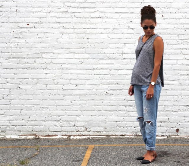 gray sleeveless sweater with scoop neckline and relaxed light blue jeans