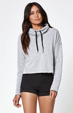 gray, slightly shortened hoodie with black mini-shorts