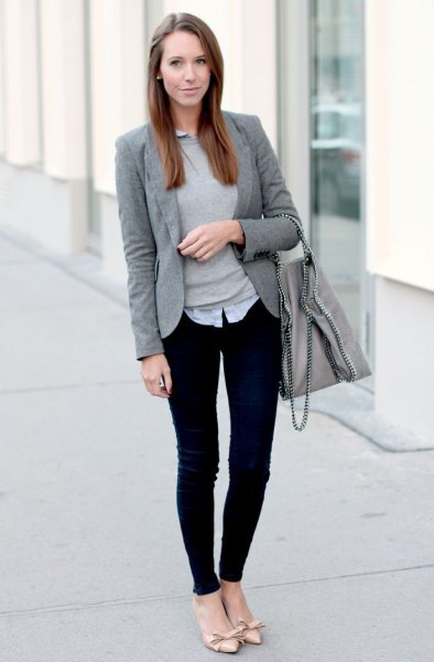 gray sweater with a light blue collar shirt and black, narrow chinos