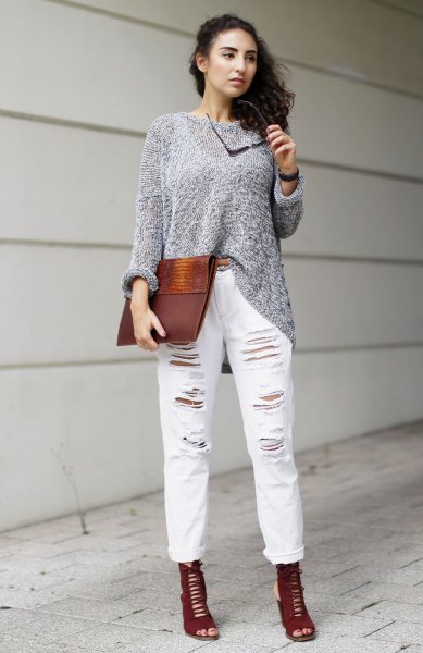 gray sweater with ripped white boyfriend jeans with cuffs