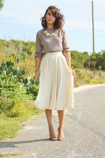 gray sweater with statement chain with white, flowing midi skirt