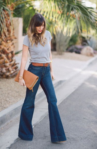 gray t-shirt with blue belt and high-waisted flare jeans
