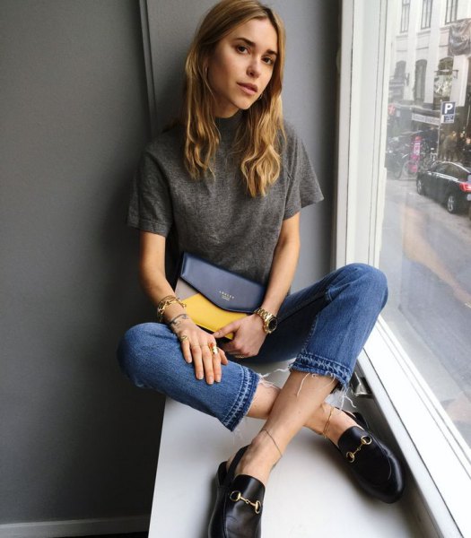 gray t-shirt with blue cut jeans and leather slip-on slippers
