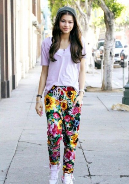gray t-shirt with floral baggy pants and white high-top sneakers