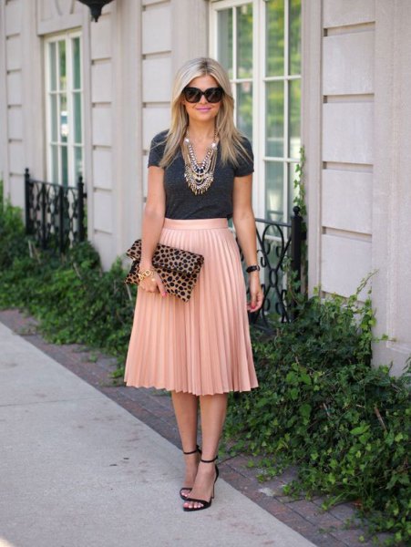 gray t-shirt with rose gold colored high-rise pleated skirt
