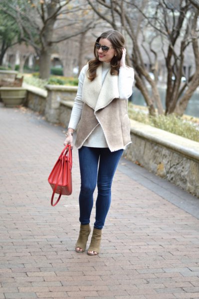 gray vest with white T-shirt and blue skinny jeans