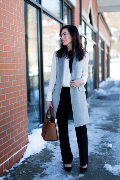 gray wool longline vest with white blouse and black chinos with straight legs