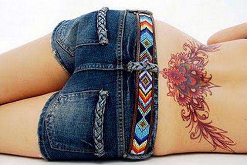 Hawaiian flower tattoo on the lower back