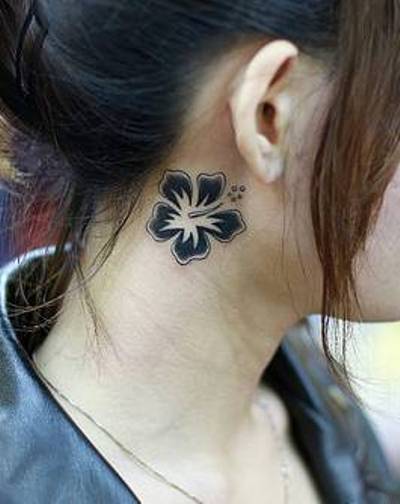 Hawaiian flower tattoo on the side of the neck
