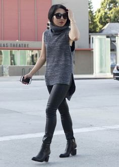gray sleeveless gray sweater with black leather gaiters