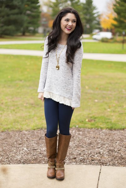 heather gray tunic sweater with dark blue leggings and brown knee-high boots