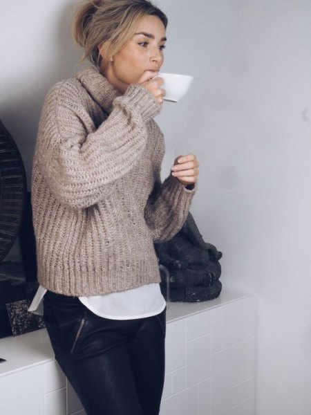 gray, chunky sweater with a high neck, black leather pants