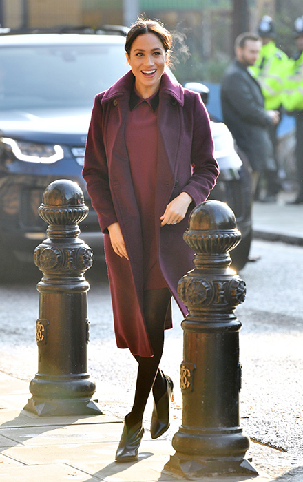 Meghan Markle stuns in a burgundy dress and coat by Club Monaco on .