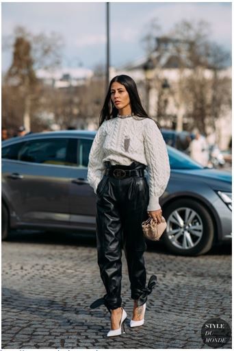 Oversized chunky sweater with belted high waisted leather pants .