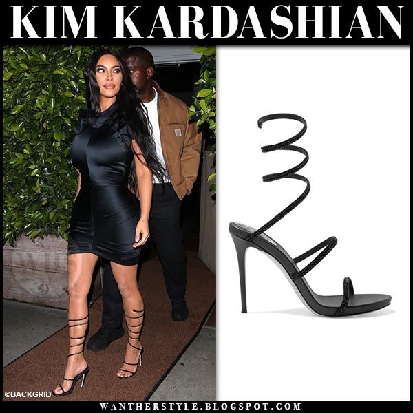 Kim Kardashian in black strappy sandals and black mini dress at .