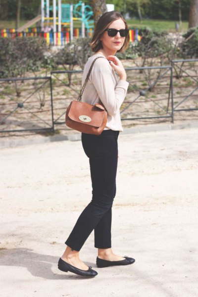 Ivory cardigan with black, cropped jeans and a small brown shoulder bag