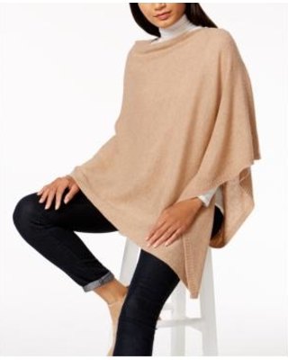 Ivory cashmere poncho over white mock neck sweater