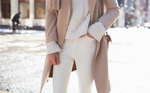 chunky ivory sweater with red coat and cream-colored jeans