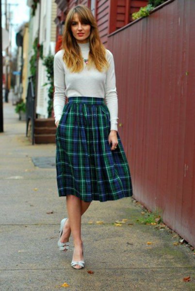 Ivory mock neck sweater with a flared midi checked skirt