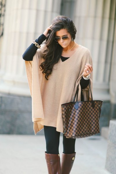 Ivory ribbed cape sweater with black leggings and gray over-the-knee boots