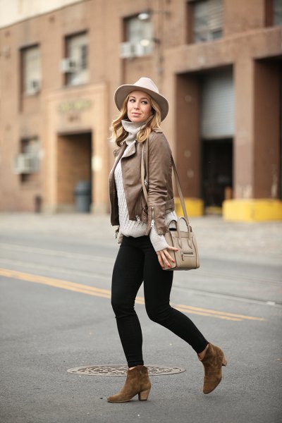 Leather jacket with a gray turtleneck and a white felt hat